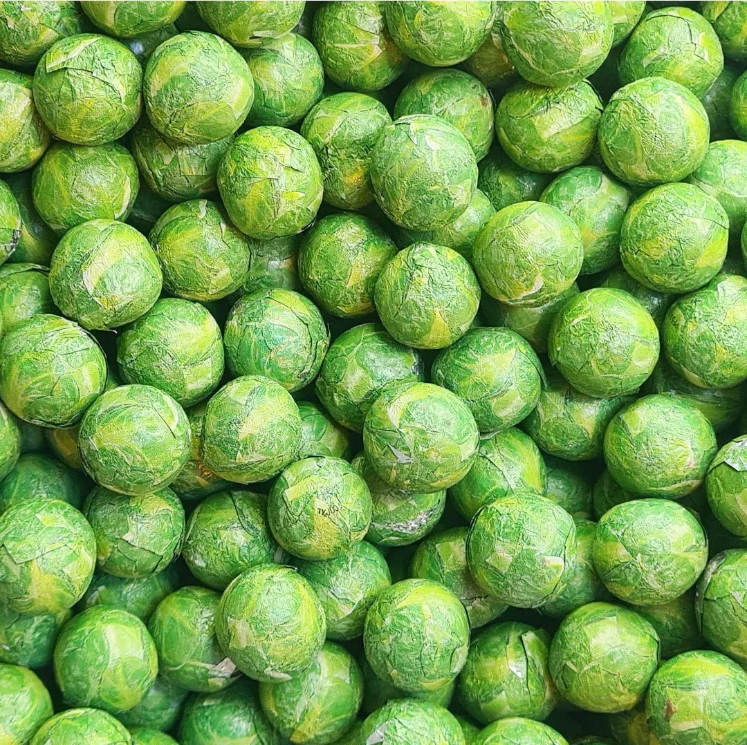 Milk chocolate Sprouts by Gummy Galaxy, a close-up of chocolate sprout candies in a clear bag, showcasing their smooth milk chocolate coating.